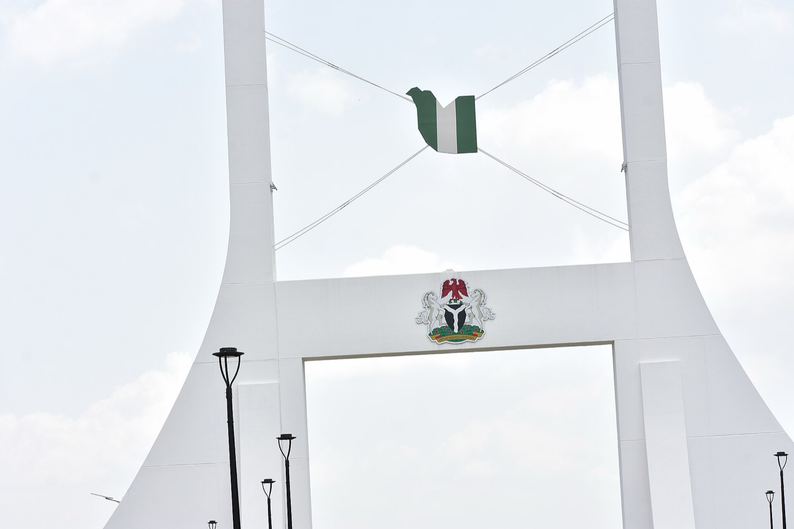 The green-white-green Nigerian flag flying at the Abuja City Gate
